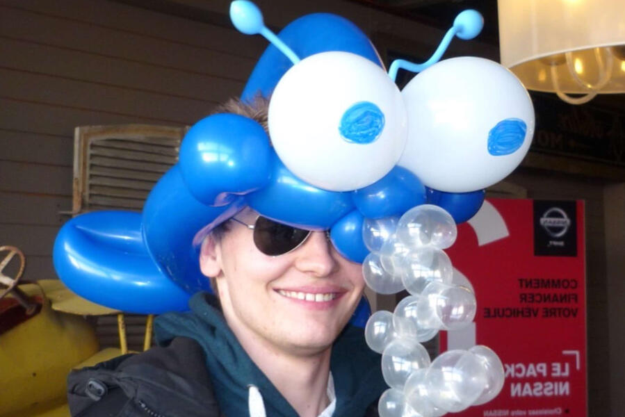 Sculpture de ballons colorés attirant le public autour de l’animateur